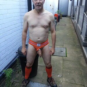 The dead-end back alley with my cock hanging out of an orange Jock Mail jockstrap