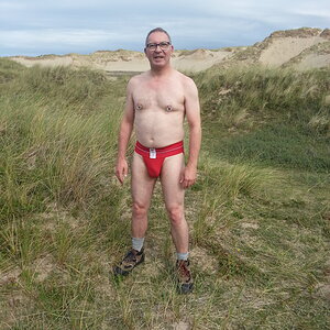 Front view of the red Wang Jiang jockstrap while walking through the dunes to get to the beach