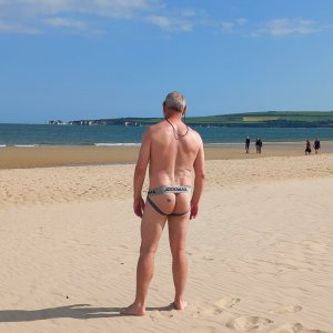On the beach in my grey Jockmail jockstrap while clothed 'willy-watchers' walk on the nude beach!