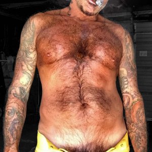 STINKYDONGER SMOKING A CIGAR IN A YELLOW LACE UP JOCKSTRAP