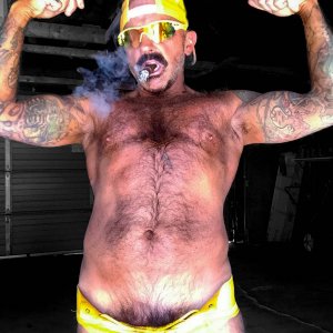 STINKYDONGER FLEXING HIS MUSCLES IN A YELLOW LACE UP JOCKSTRAP