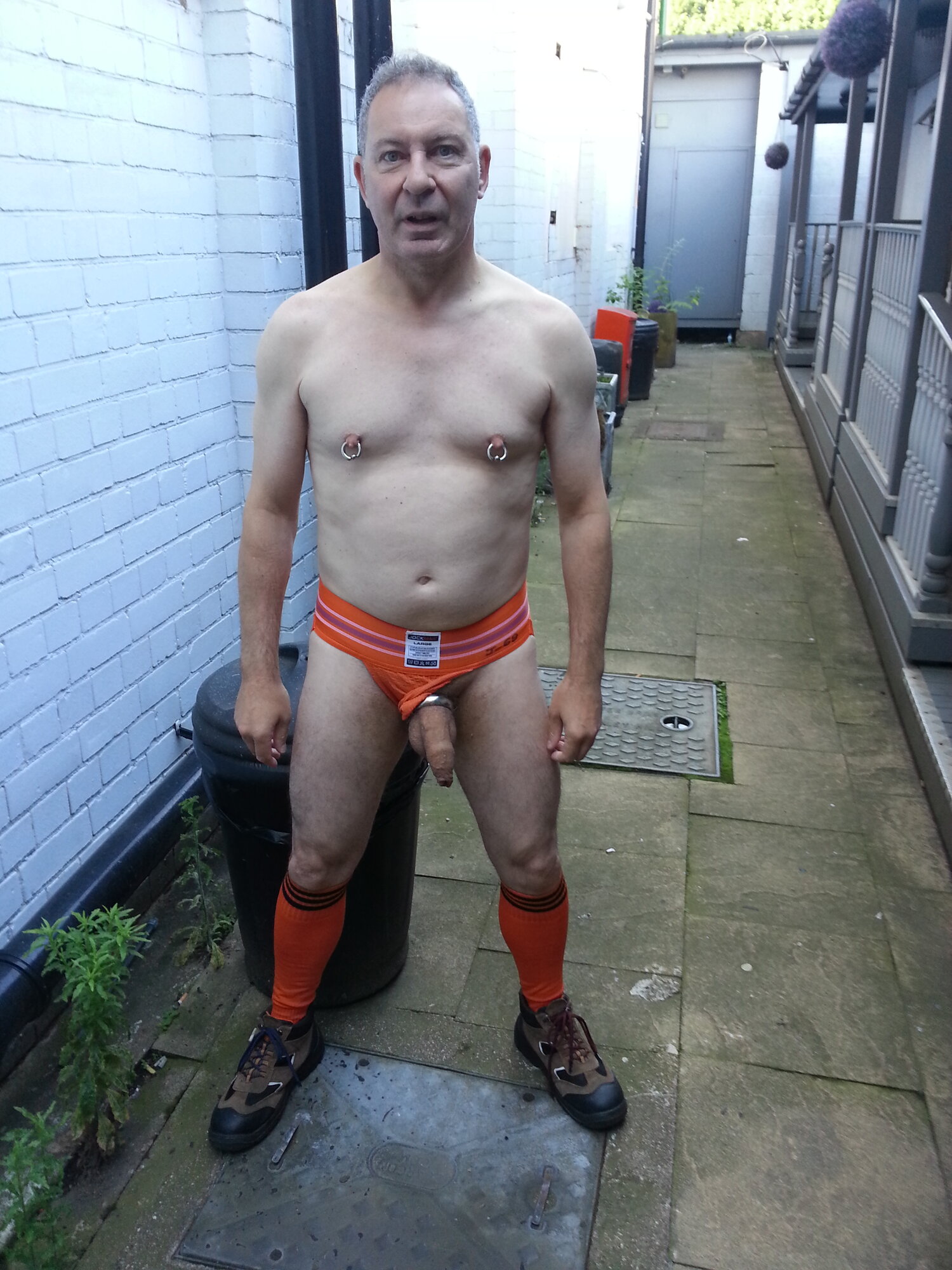 The dead-end back alley with my cock hanging out of an orange Jock Mail jockstrap